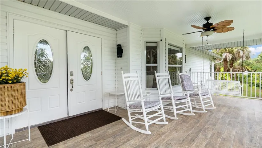 Entrance to property featuring a ceiling fan and covered porch
