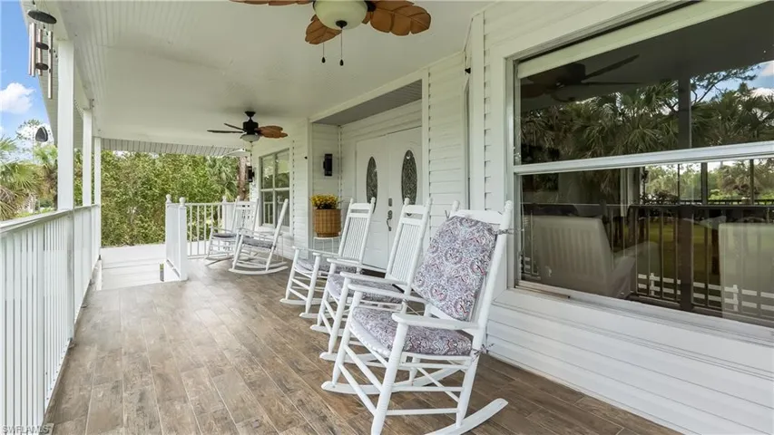 Wooden deck featuring a porch and ceiling fan