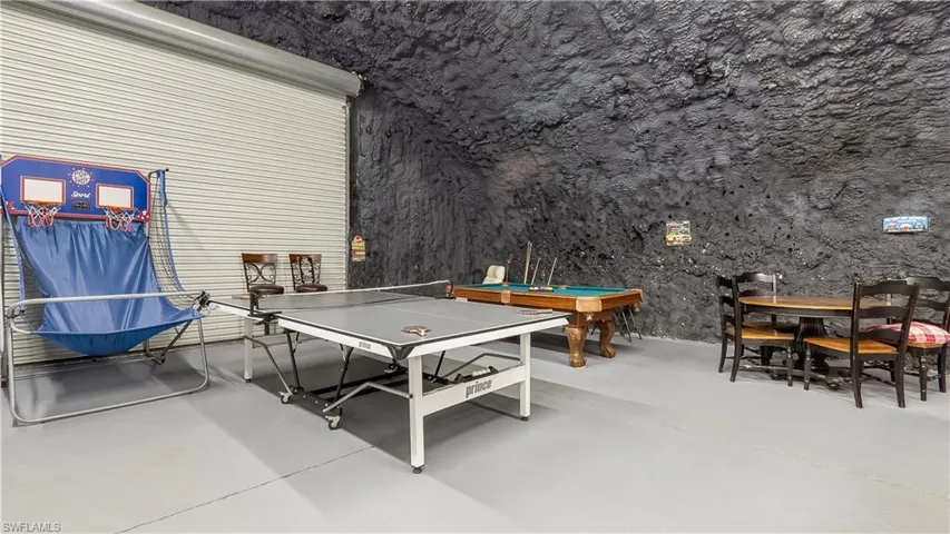 Rec room with concrete flooring and billiards