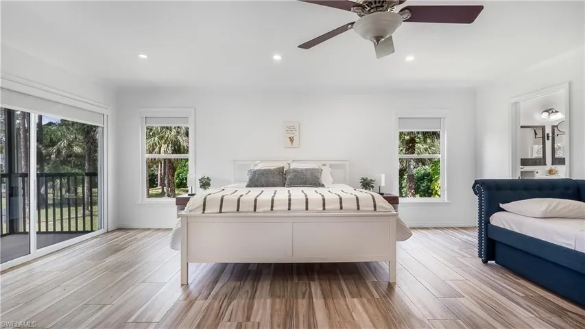 Bedroom with recessed lighting, light wood-type flooring, and multiple windows