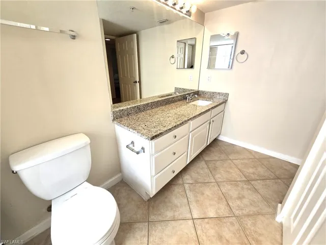 Extra wide vanity with one sink, tile on diagonal, linen closet