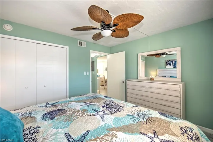 Bedroom with ceiling fan and a closet