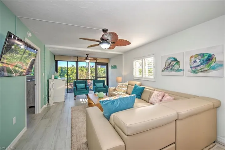 Living room with light hardwood / wood-style floors and a textured ceiling