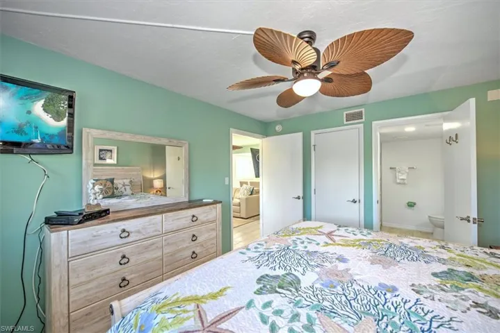 Bedroom featuring connected bathroom and ceiling fan
