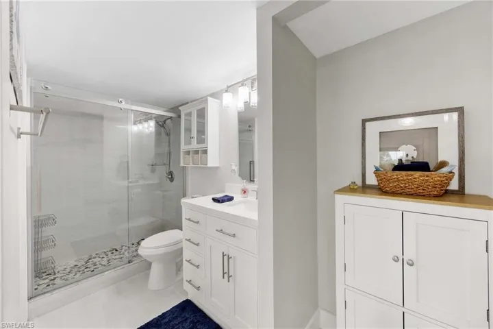 Bathroom featuring vanity and a shower stall