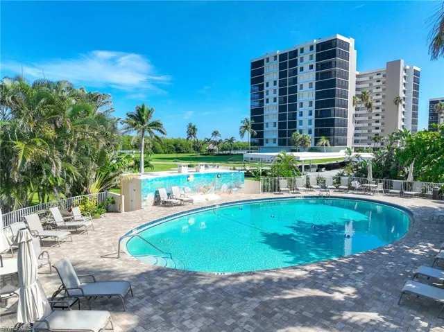 Community pool with a patio