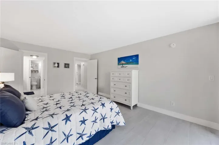 Bedroom featuring baseboards and ensuite bath