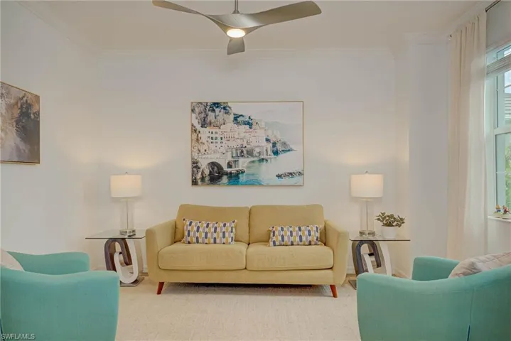 Spacious Den with french doors featuring crown molding and ceiling fan