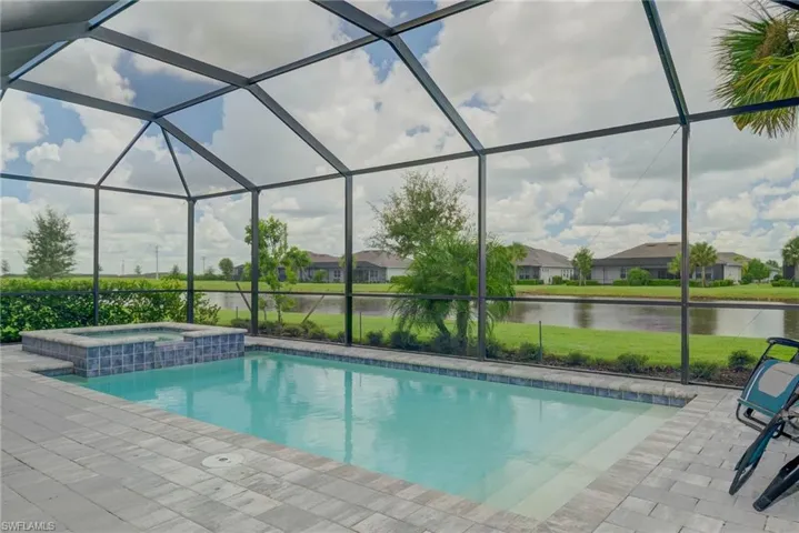 Gorgeous view of swimming pool with hot tub, overlooking lake and SW view for those Awesome Sunsets!