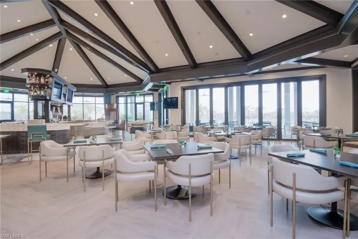 "Champions Table" Dining room, complete with full bar, with beamed ceiling and high vaulted ceiling