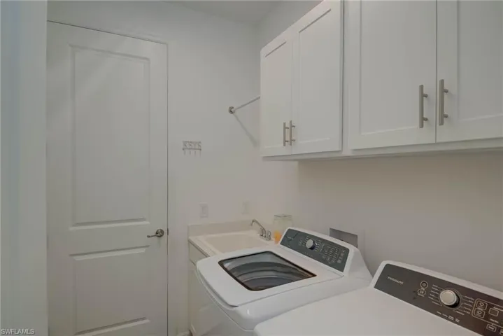 Laundry area with cabinet space, laundry tub and washer and dryer