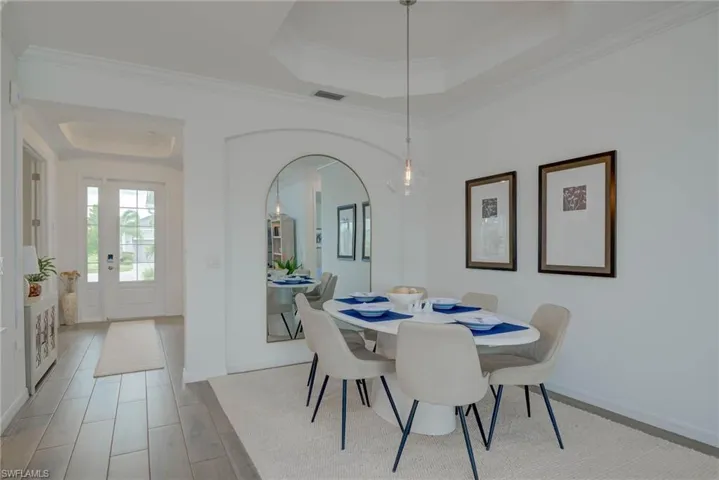 Dining space with a tray ceiling