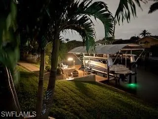 Dock featuring 8000 pound boat lift and a yard with snook light.