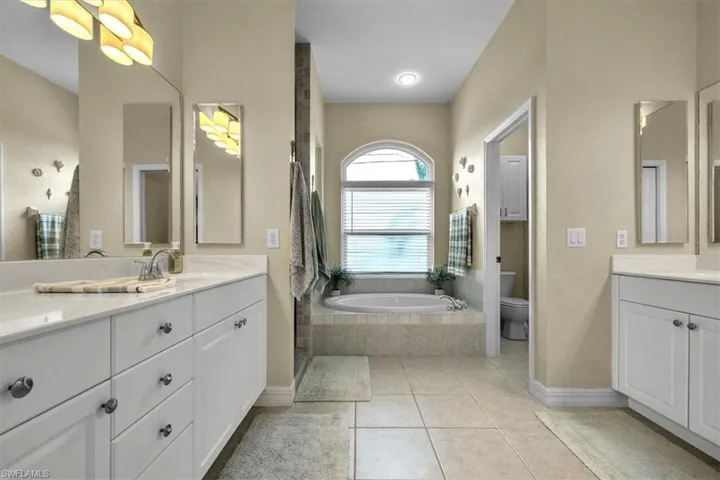 Bathroom with a bath, walk in shower, and tile patterned floors