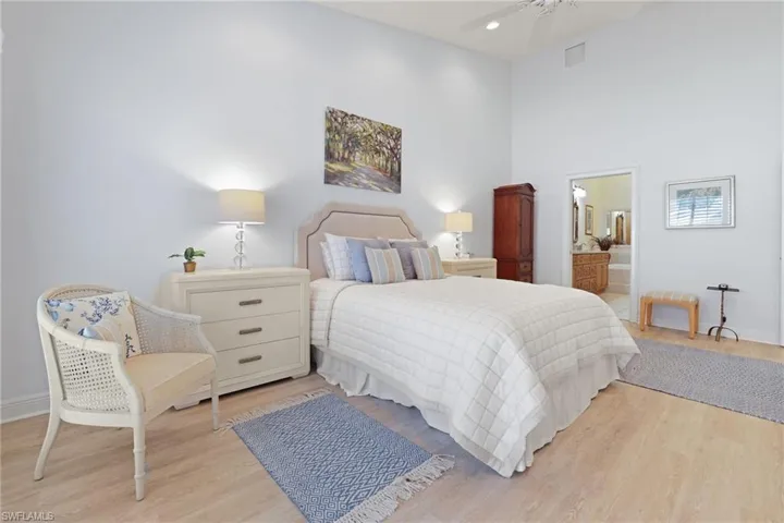 Bedroom featuring connected bathroom and light wood-type flooring