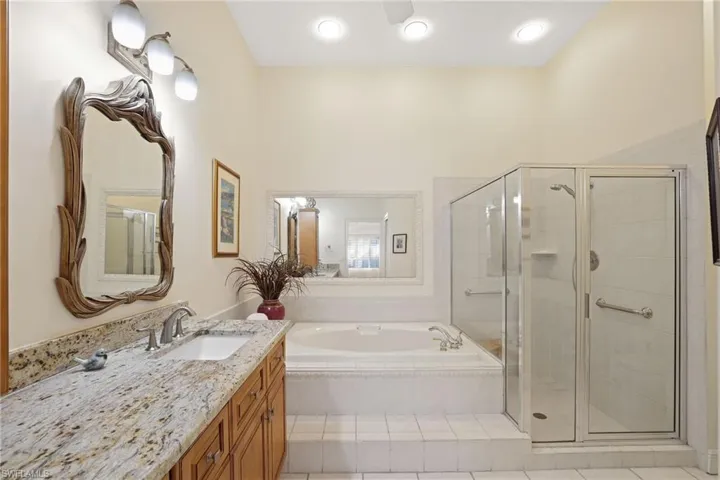 Bathroom with vanity and separate shower and tub