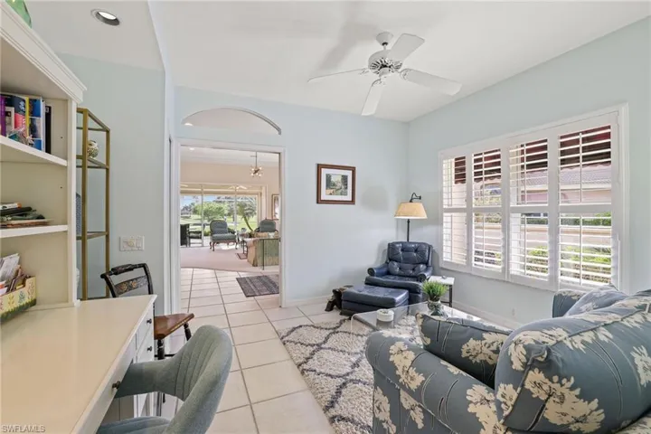 Tiled living room featuring ceiling fan