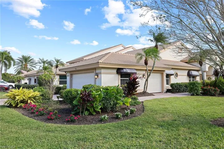 View of front of house with a garage and a front yard
