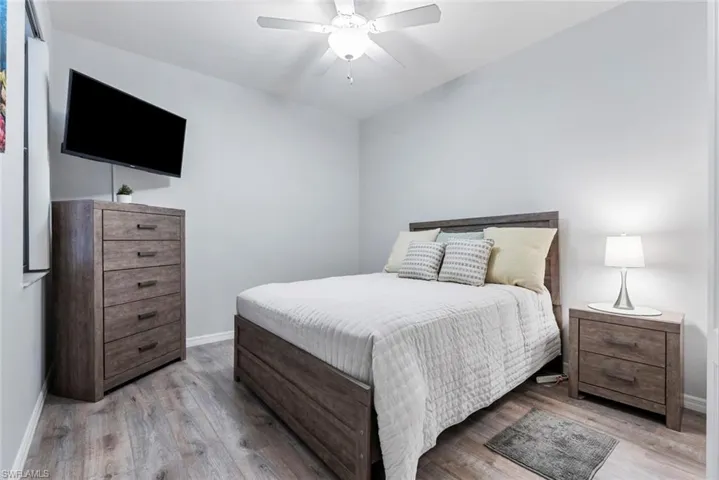 Bedroom with ceiling fan and light wood-type flooring