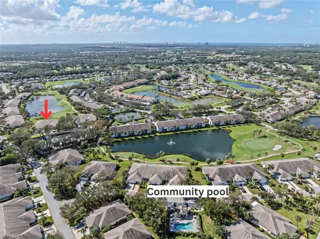 Birds eye view of property with a water view
