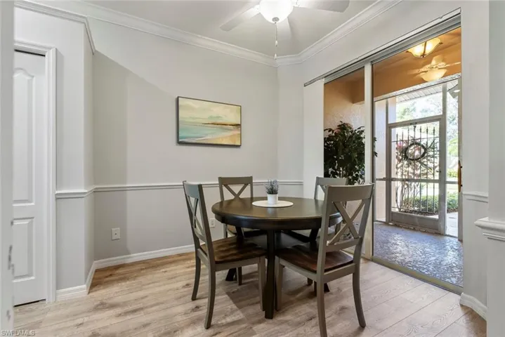 Dining room featuring crown molding, light wood-type flooring, and ceiling fan