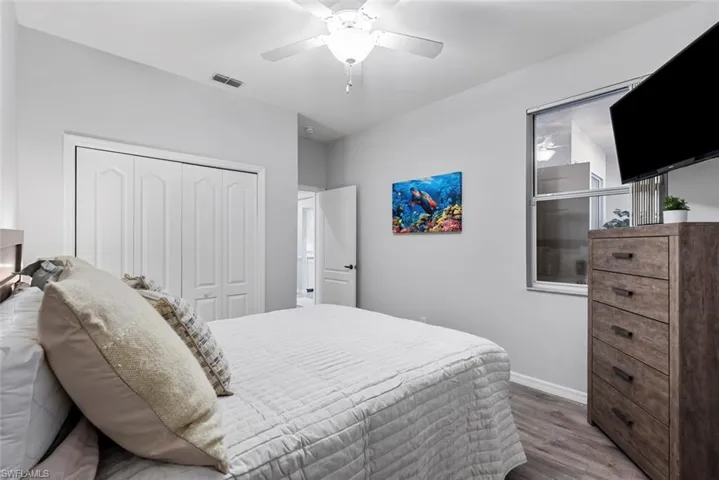 Bedroom with a closet, wood-type flooring, and ceiling fan