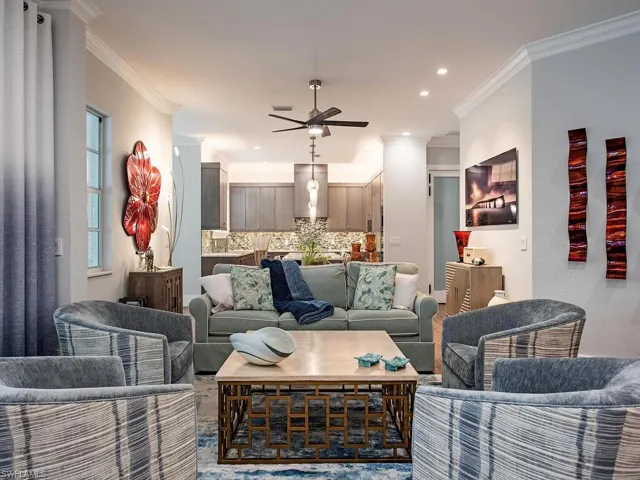 Living room with ceiling fan and crown molding