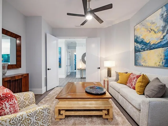 Living room with ceiling fan and light wood-type flooring