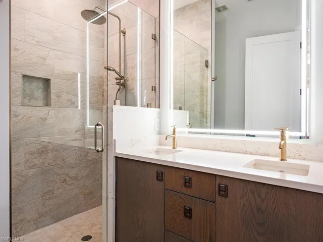 Bathroom with a shower with door and vanity