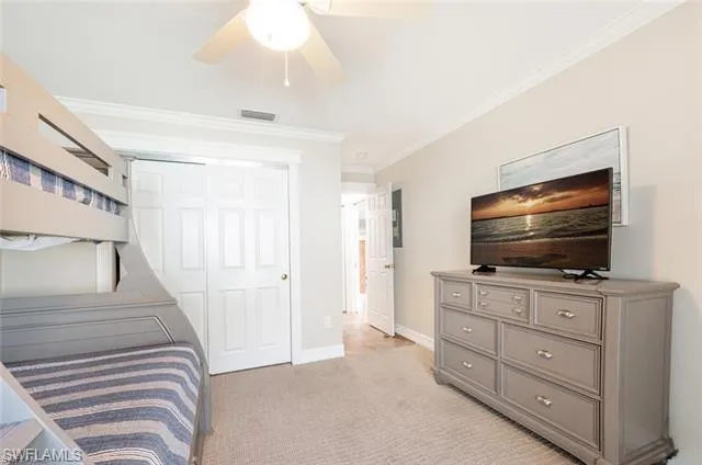 Primary Bathroom featuring walk in shower, vanity, tile floors, and crown molding