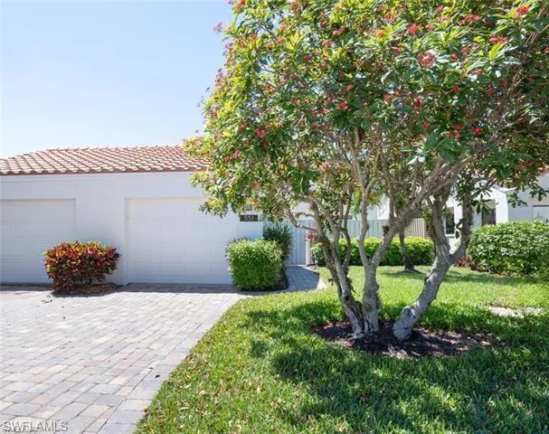 View of front of home featuring a garage and a front lawn
