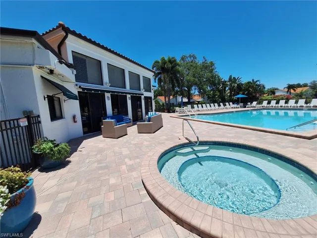 View of swimming pool with outdoor lounge and spa area, a patio area, and a hot tub