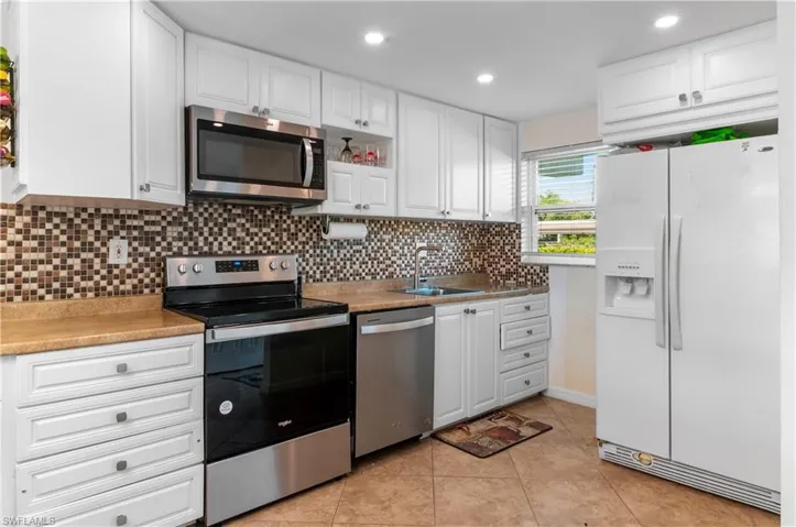 Newer kitchen cabinets and appliances, impact windows.