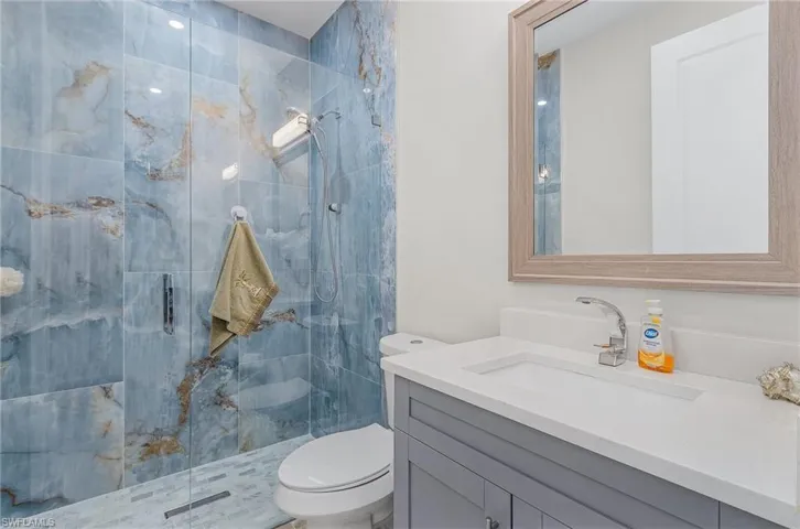 Bathroom with vanity and a stall shower