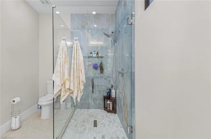 Full bath featuring a shower stall
