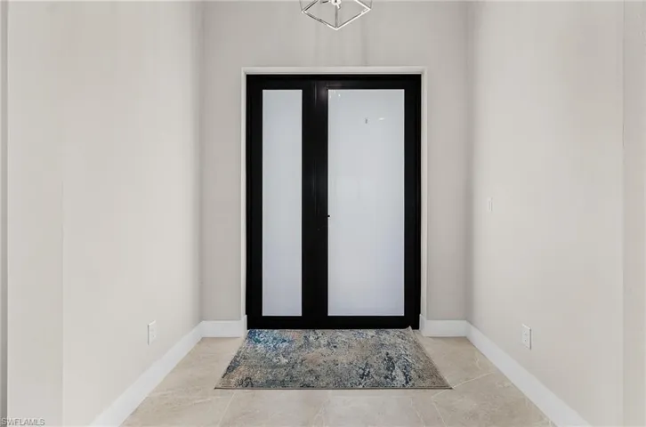 Entryway featuring baseboards and tile patterned flooring
