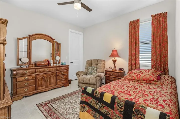 Bedroom featuring a ceiling fan and light tile patterned flooring
