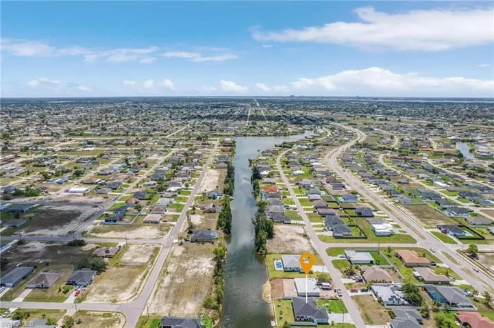 Aerial view of property's location featuring nearby suburban area and a nearby body of water