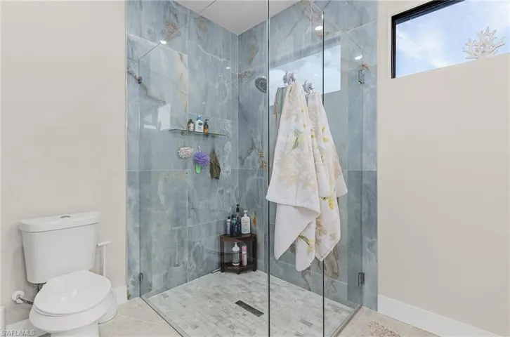 Bathroom featuring a stall shower and tile patterned flooring