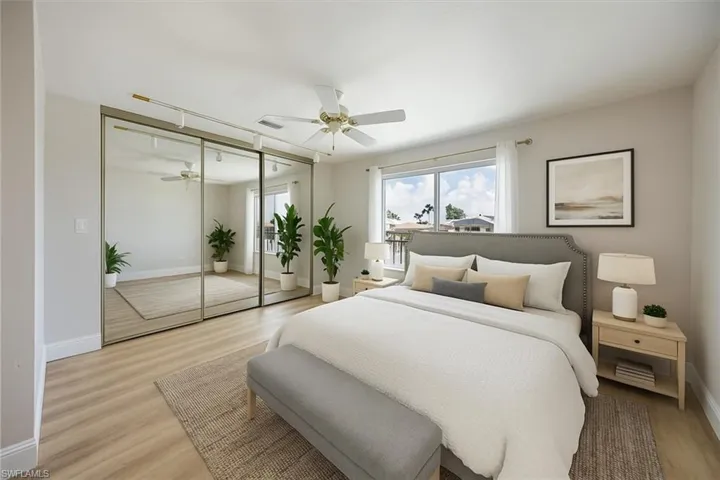 Virtually staged showing the bright and open bedroom overlooking the water