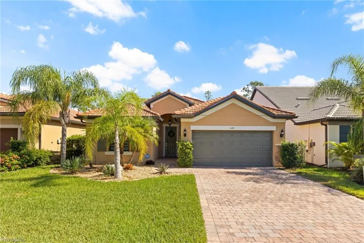 View of front of house featuring a garage and a front lawn