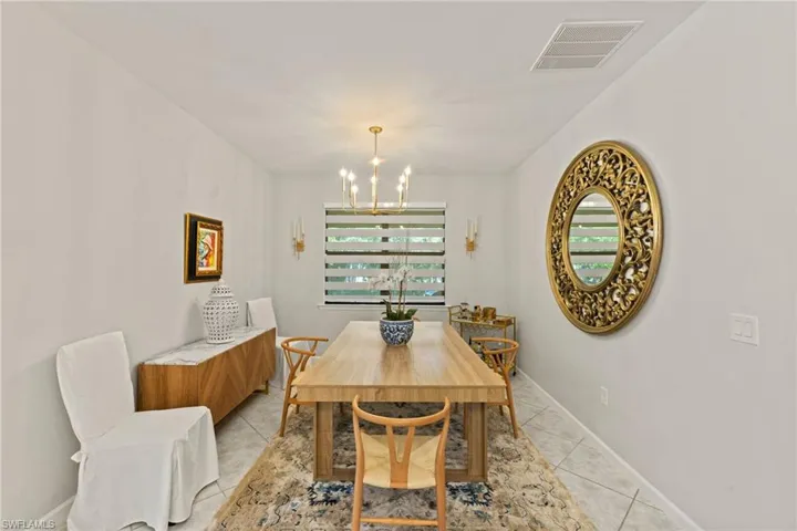 Tiled dining area with an inviting chandelier
