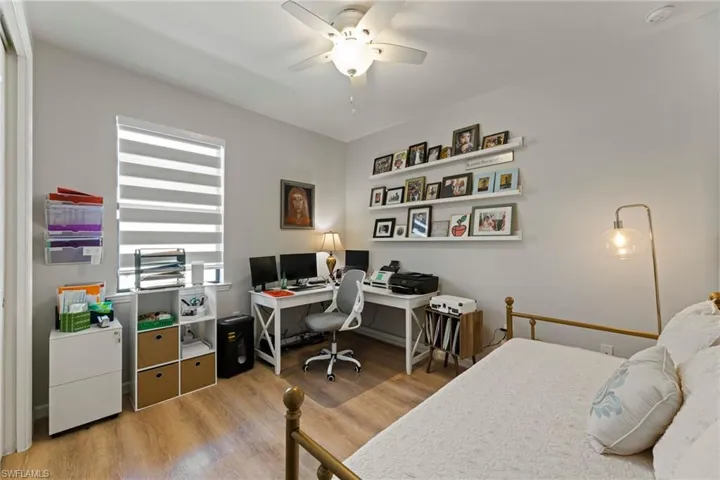 Guest Bedroom/Office with ceiling fan and wood-type flooring