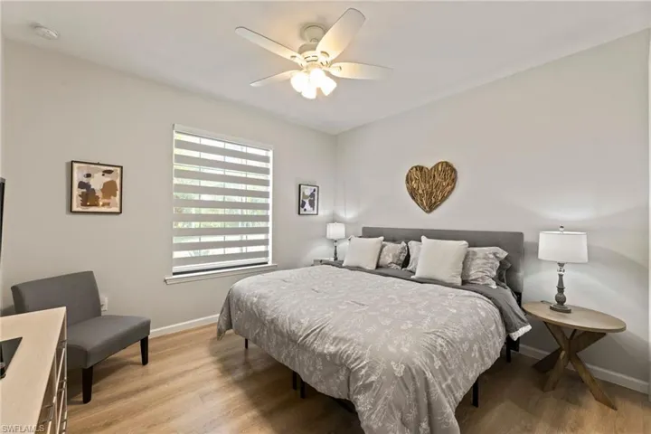 Guest Bedroom featuring light hardwood / wood-style floors and ceiling fan