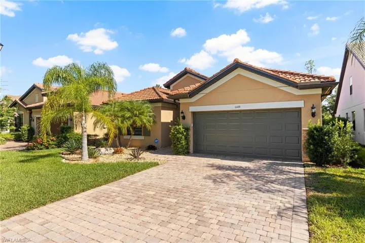 View of front of house featuring a garage and a front lawn