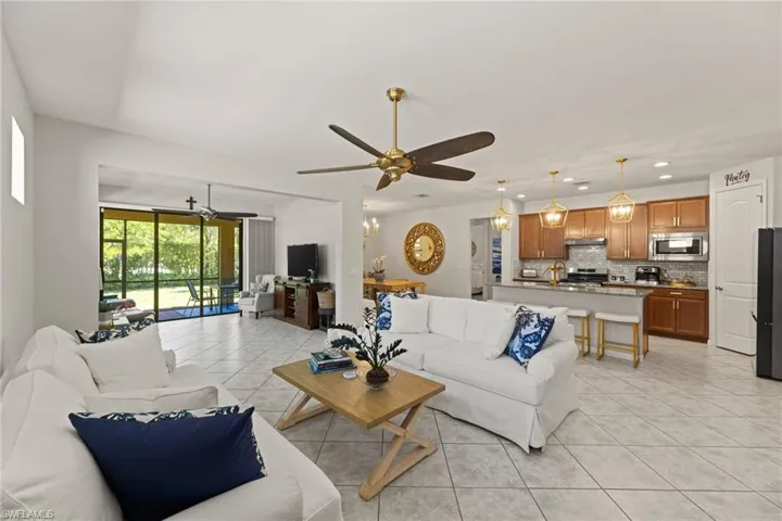 Living room featuring ceiling fan and light tile flooring