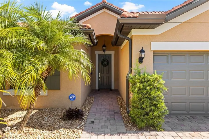 View of exterior entry with a garage
