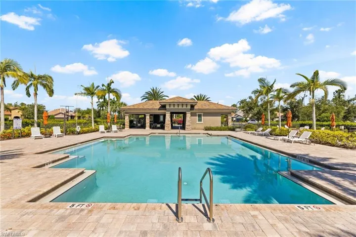 View of community swimming pool with a patio area