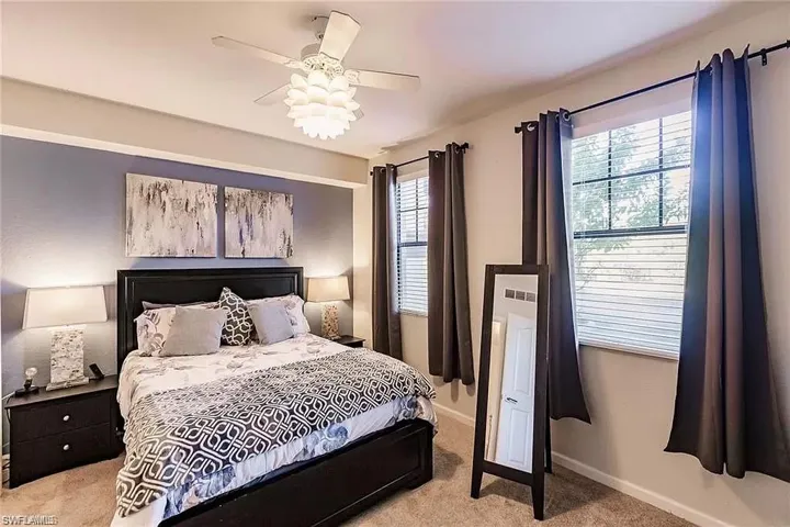 Bedroom featuring light colored carpet and a ceiling fan