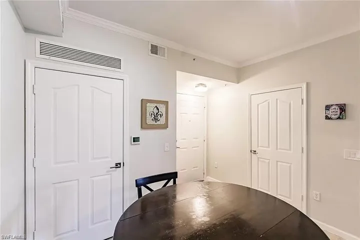 Dining area with ornamental molding and baseboards